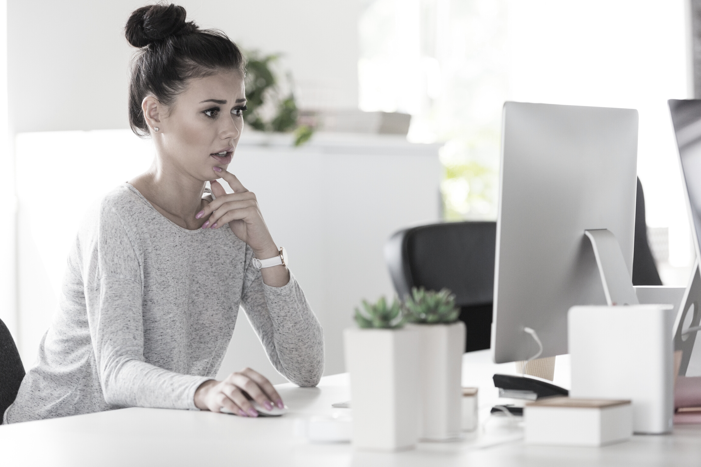 Female computer programmer looking worried while working